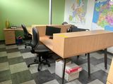 two desks with chairs and a map on the wall