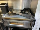 an oven with a pan on top of it in a kitchen