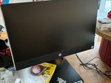 a computer monitor sitting on top of a wooden desk
