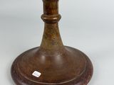 a small globe on a wooden stand on a white surface