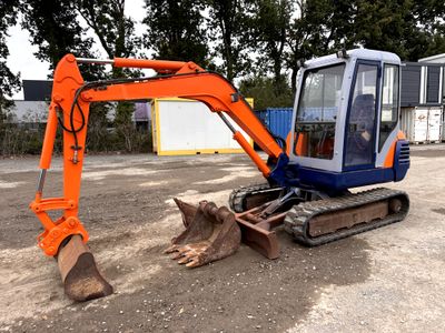 an orange and blue excavator sitting in the dirt