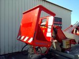 a red crane that is parked in front of a building