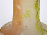 a glass vase with a yellow and green design on it