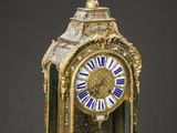 a gold clock sitting on top of a marble table