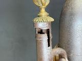 a metal fire hydrant that is on a wooden table