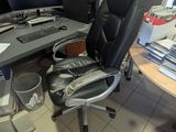 a desk with a computer and a chair in a room
