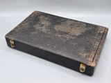an old book sitting on top of a white table
