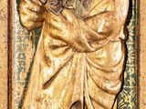 statue of a man holding a musical instrument in his right hand