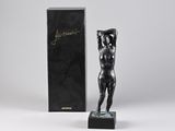 a statue of a woman holding a box with a box in the background