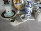 many different types of vases and teapots on the table