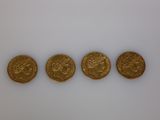 three gold sovereigns, one of which is a sovereign and the other of which is a sovereign