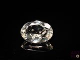 a close up of a white diamond on a black surface