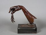 bronze sculpture of a hand holding a piece of wood on a marble base
