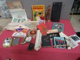 a table with a red table cloth covered with various items