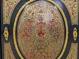 an image of a decorative cabinet with gold and black paint