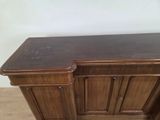 a wooden cabinet with two drawers and a door