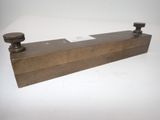 an old brass plate with two knobs on a white background