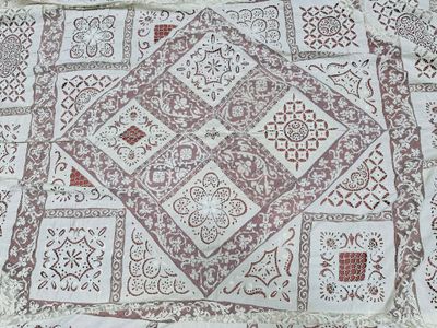 an image of a white and red patchwork rug on a table