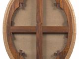 an image of a round wooden shelf with a wooden cross on it