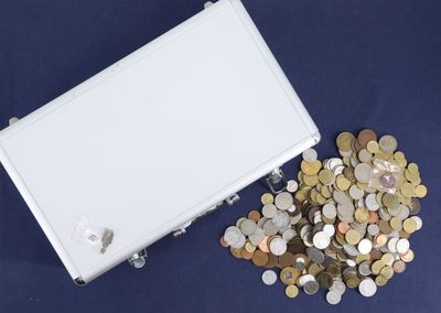 a white box filled with lots of coins on a blue surface