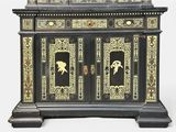 a black and gold cabinet with a mirror on top