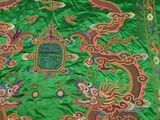 a close up of a green cloth with a dragon design on it