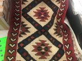 an image of a red and black rug on a table