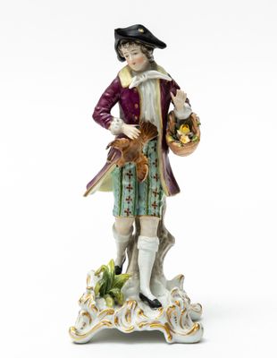 an image of a figurine of a man with a basket of fruit