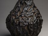 a black vase that has a lot of designs on it