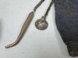 a small metal object on a table next to a pair of scissors