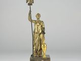 bronze statue of a woman holding a bird and a pot on a marble base