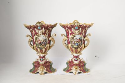 two vases are sitting on a white surface with a white background