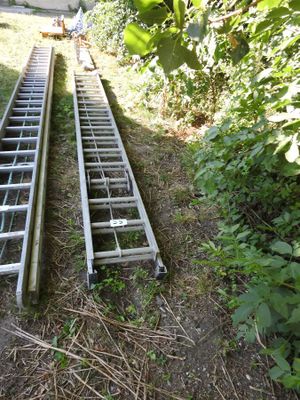 two ladders that are sitting in the grass