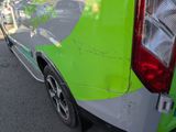 a green van that is parked on the side of the road