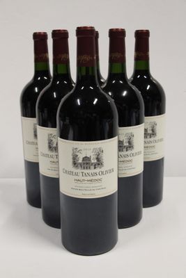 four bottles of red wine are lined up on a white surface