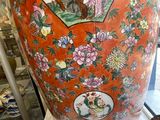 a large orange vase with a picture of a woman on it