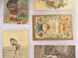 many old postcards of children on display in a display case