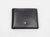 a black leather wallet with a gold button on the front