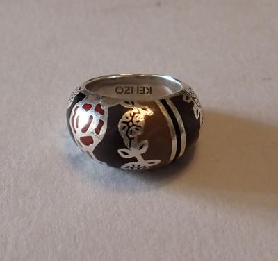 une bague en argent ornée d'un motif noir et rouge