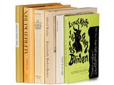 three books are stacked on top of each other on a white surface