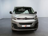 the front of a silver citrole parked in a white room
