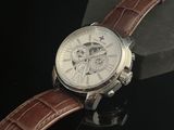 a close up of a watch with a brown leather strap