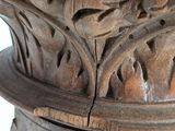 a close up of a wooden vase with a bird on it