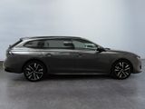 a grey car parked in a room with a white wall
