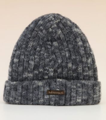 a close up of a knitted hat on a white surface