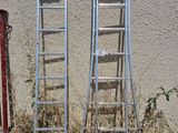 two ladders leaning against a wall next to a fire hydrant