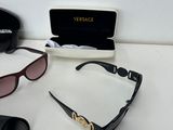 several sunglasses and a pair of glasses on a table