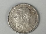 a close up of a coin on a white surface