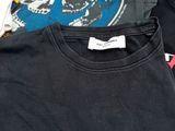 three t - shirts that are on a white table