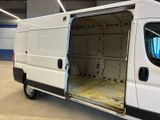 a white van with its doors open in a building